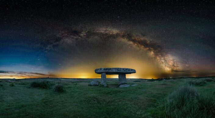 The full arch of the milky way frames Lanyon Quoit in west Cornwall