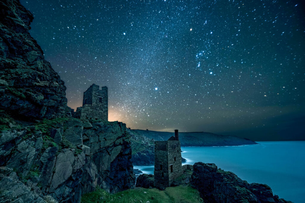 The Crown Mines Engine Houses at night with Orion and thenight sky above